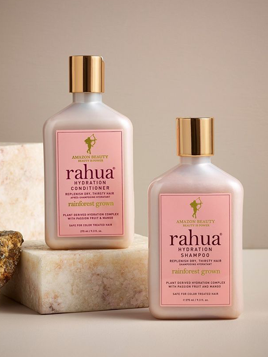 Two bottles of Rahua shampoo and conditioner on a neutral background|variant:93-oz