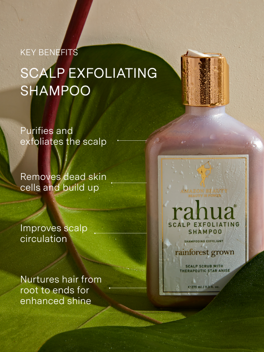 bottle of rahua scalp exfoliating shampoo sitting on a leaf with key benefits listed including purifying, exfoliating, removing build up, improving scalp circulation and nourishment|variant:93-oz
