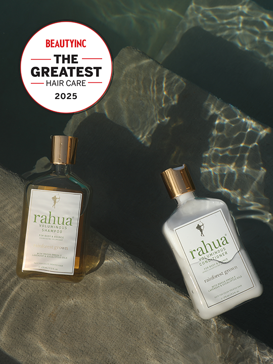 two bottles of plastic with gold caps of rahua voluminous shampoo and voluminous conditioner floating on the surface of a pool on top of concrete stairs with a sticker in the top left of beauty inc the greatest hair care 2025|variant:16-oz